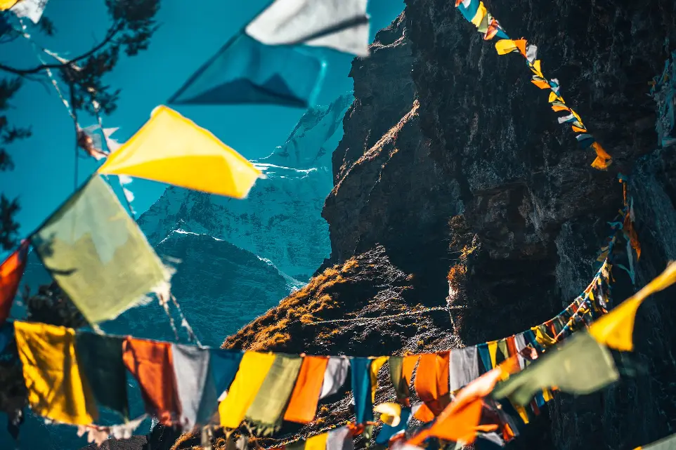 yellow and white umbrella near brown rock formation